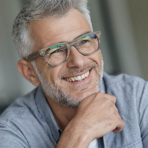 man smiling after dental implants