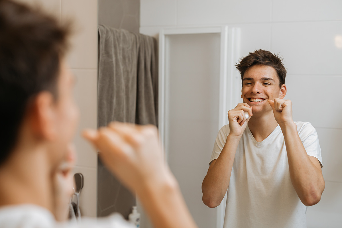 benefits of flossing daily (3) young man experiencing benefits of flossing daily
