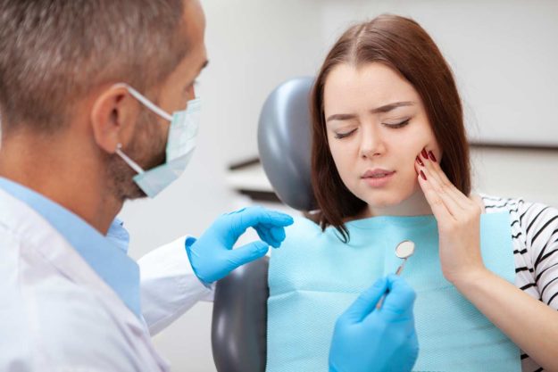 a woman seeks care for a dental emergency