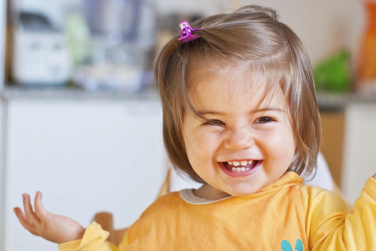 smiling baby learning When Should a Child Go to The Dentist