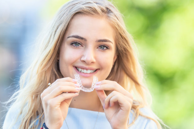 a young woman experiencing the benefits of invisalign