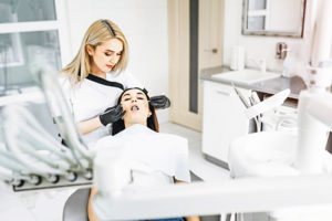 a dentist performs routine dental exams