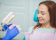 dentist explains a dental implant to a patient