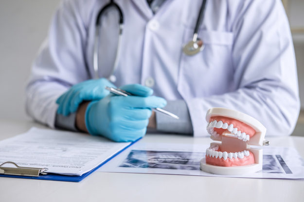 5 Signs You Need Dental Braces Again (3) dentist explaining adult dental braces